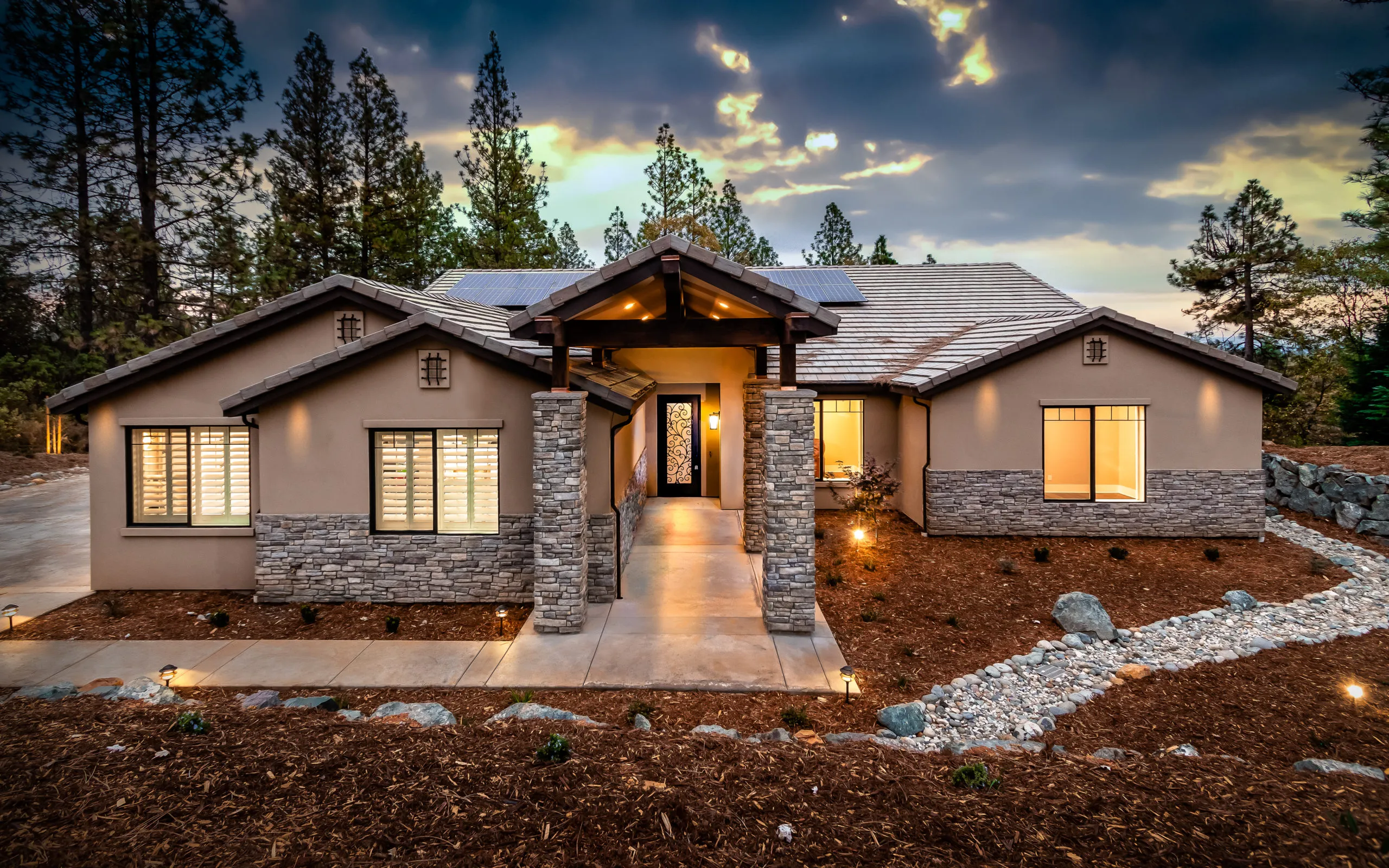 The Alpine semi-custom plan completed in the Winchester Country Club, glowing at dusk
