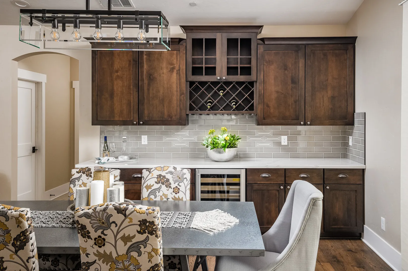 Butler's bar with lattice wine rack, glass-front cabinets, beverage cooler, and quartz counter