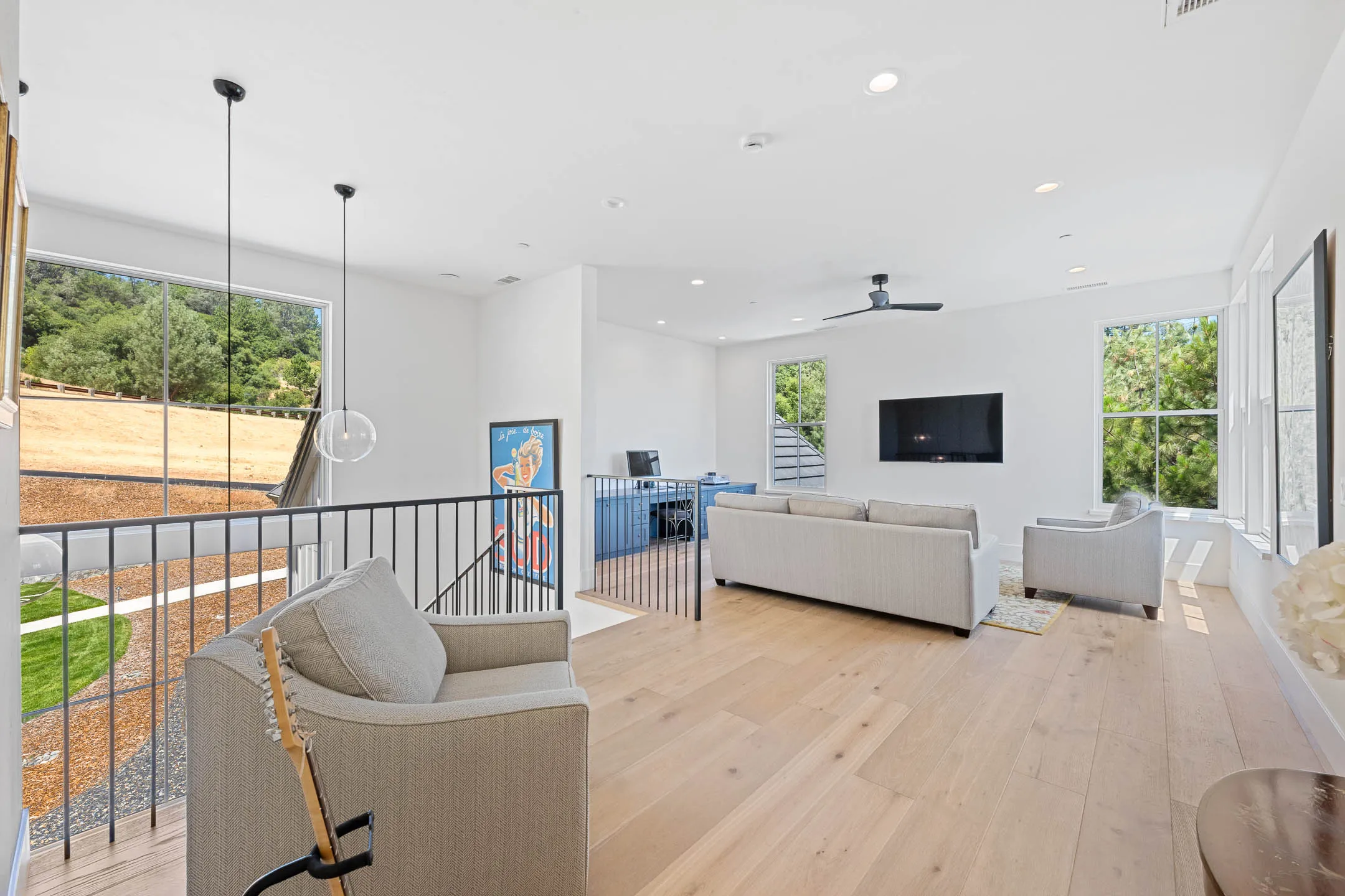 Upstairs loft lounge with built-in desk and navy cabinetry in a Sherman custom home
