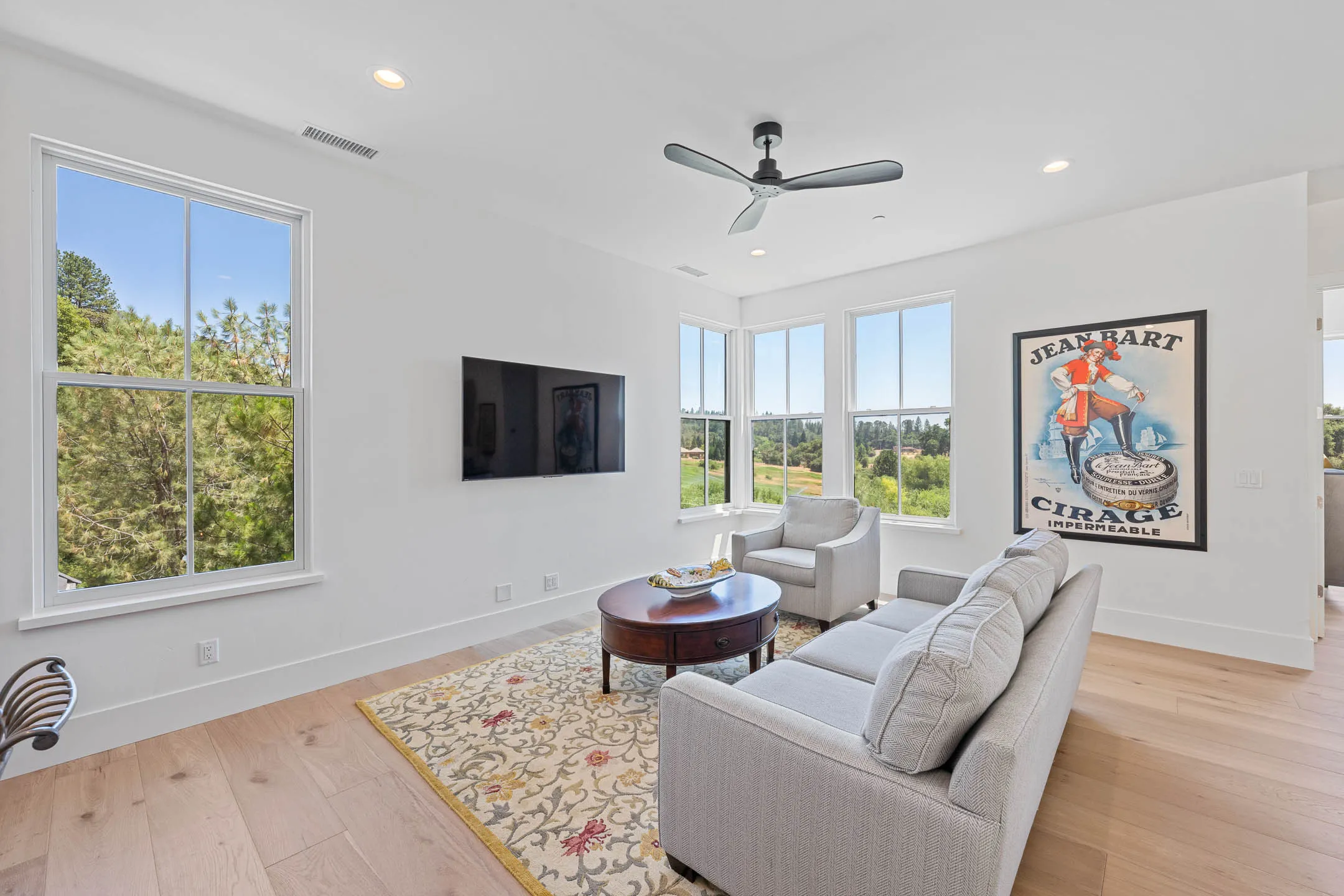 Bonus room with corner windows overlooking the golf-course treetops in a Sherman custom home