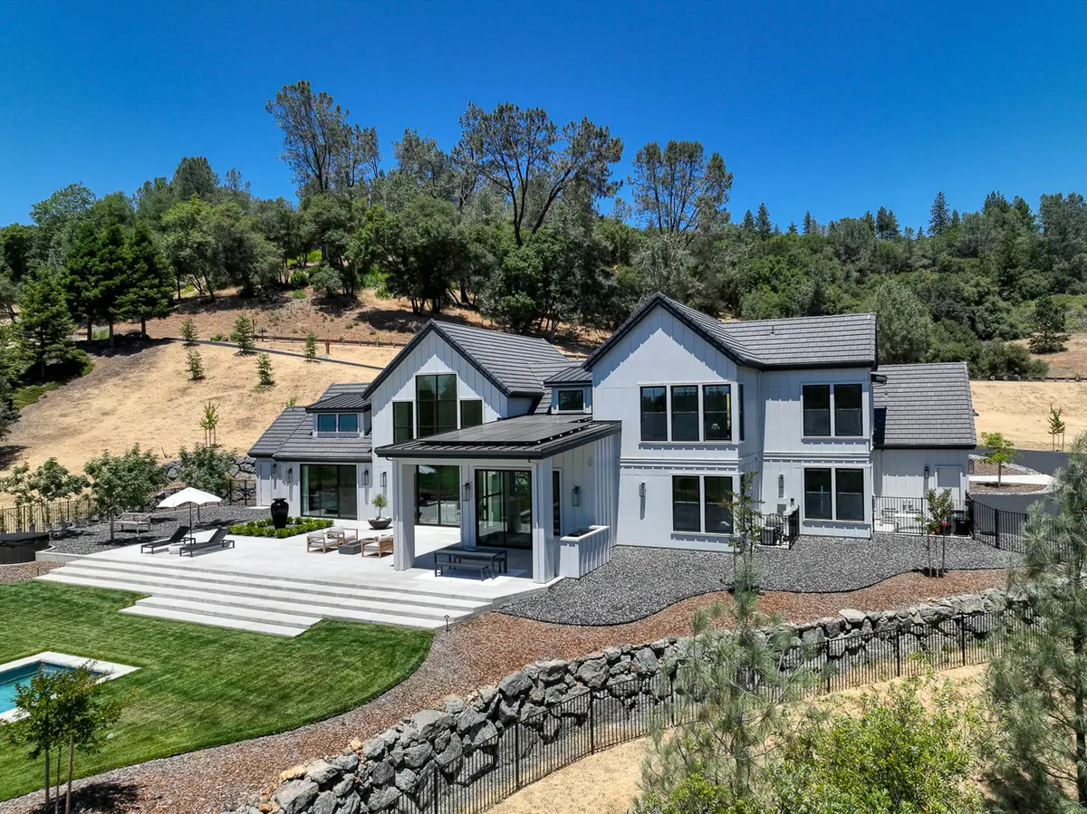 Meadow Vista · rock retaining walls tucked against an oak-studded slope