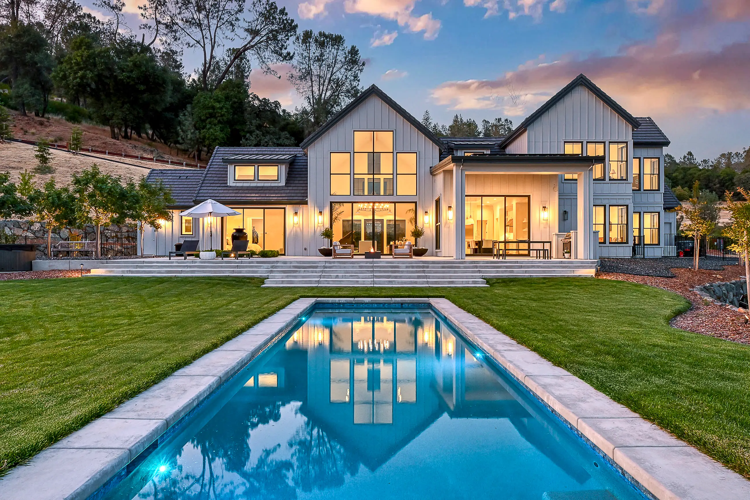 Rear elevation and pool of a completed Sherman modern farmhouse