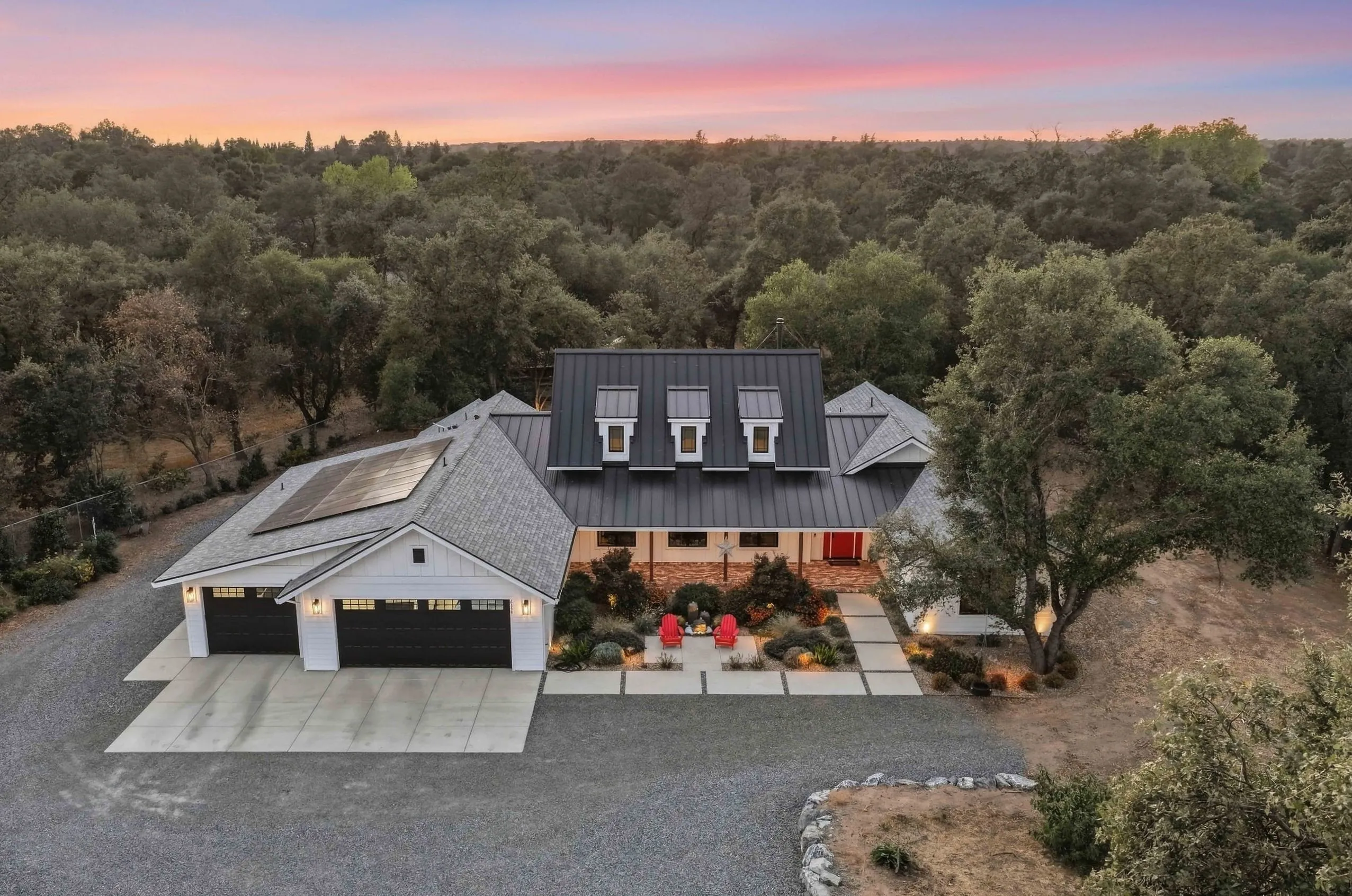 Aerial view at sunset of the farmhouse surrounded by oak woodland