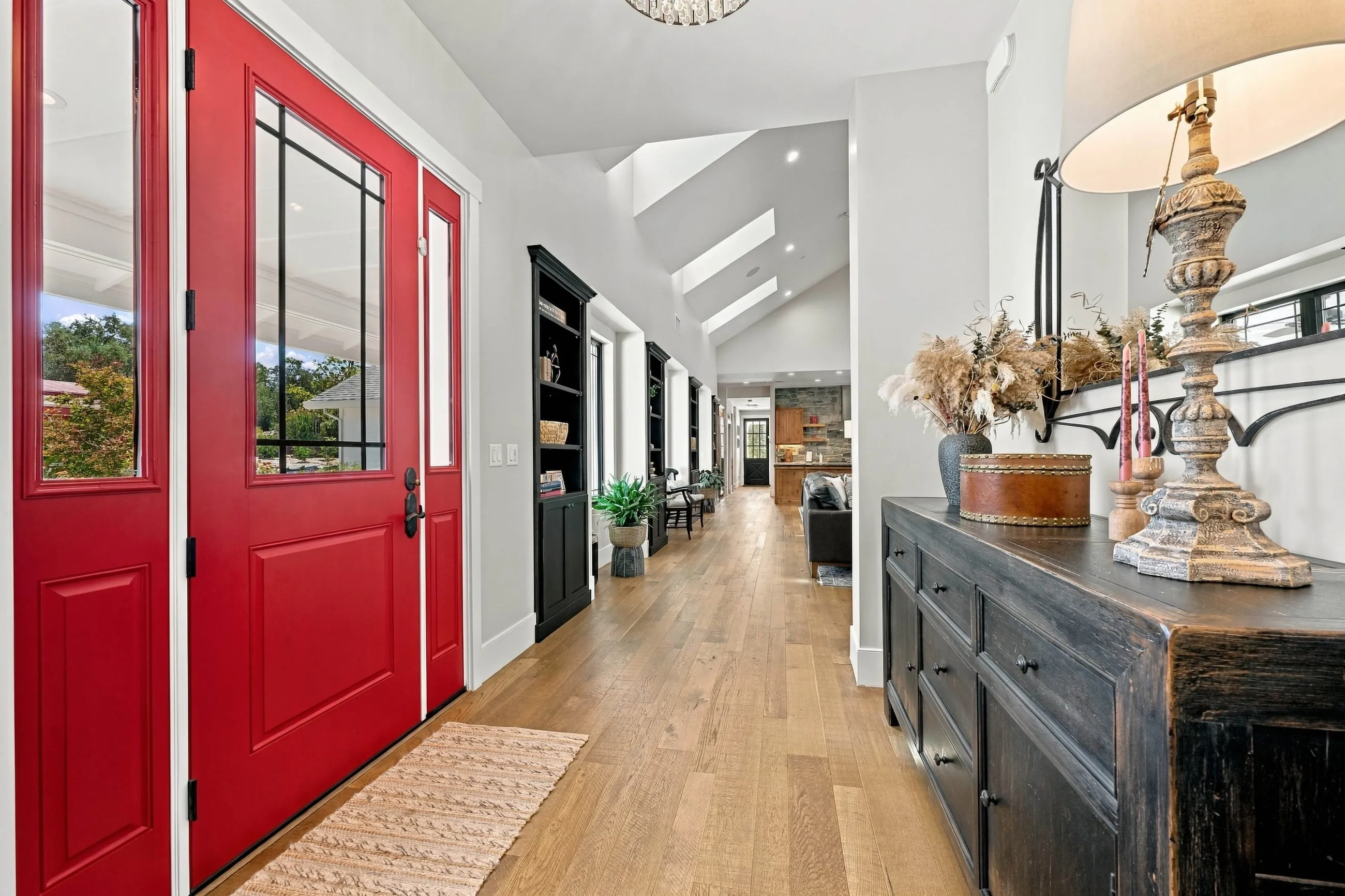 Foyer with red double entry doors and a view into the great room