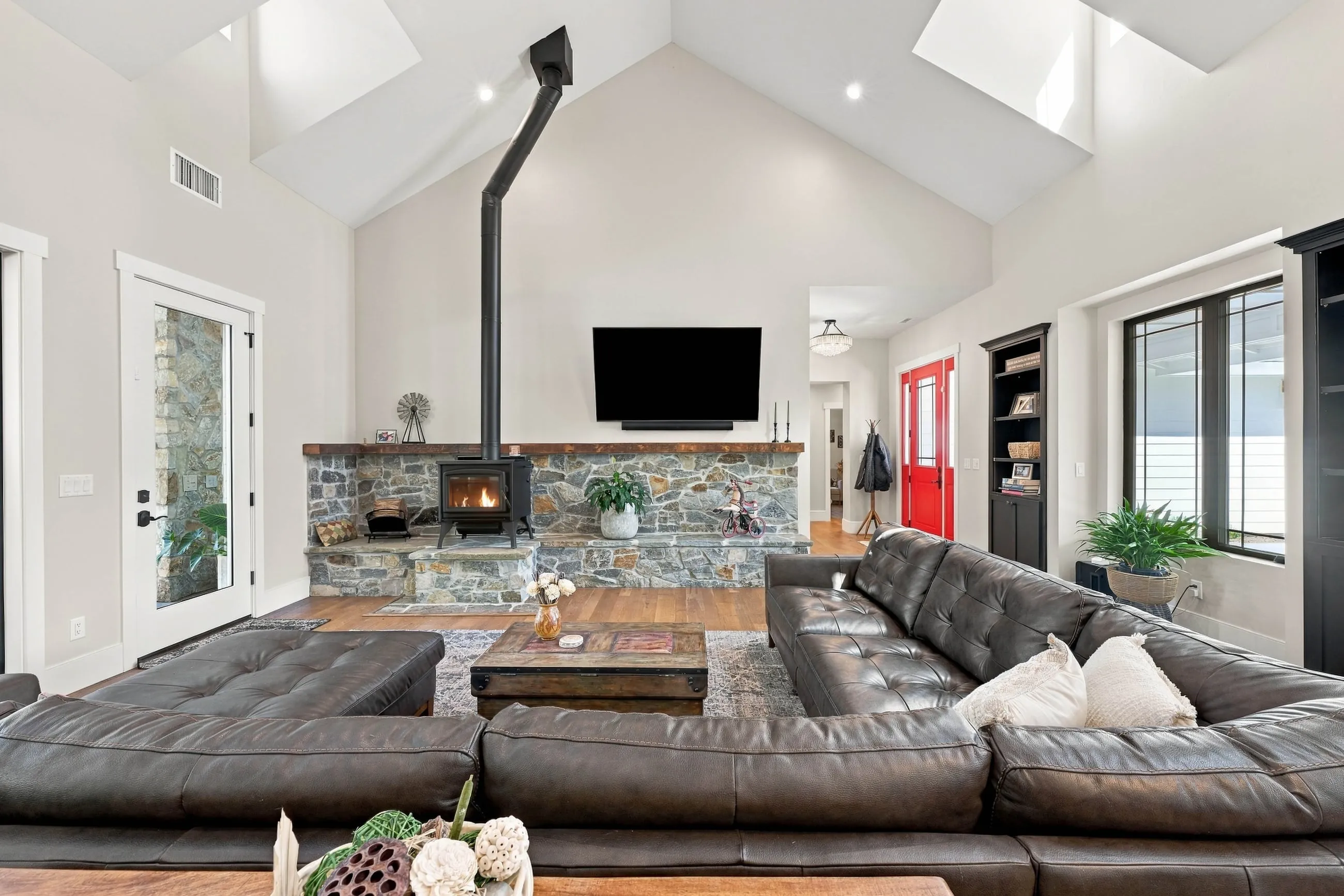 Great room with wood stove on a stacked-stone hearth