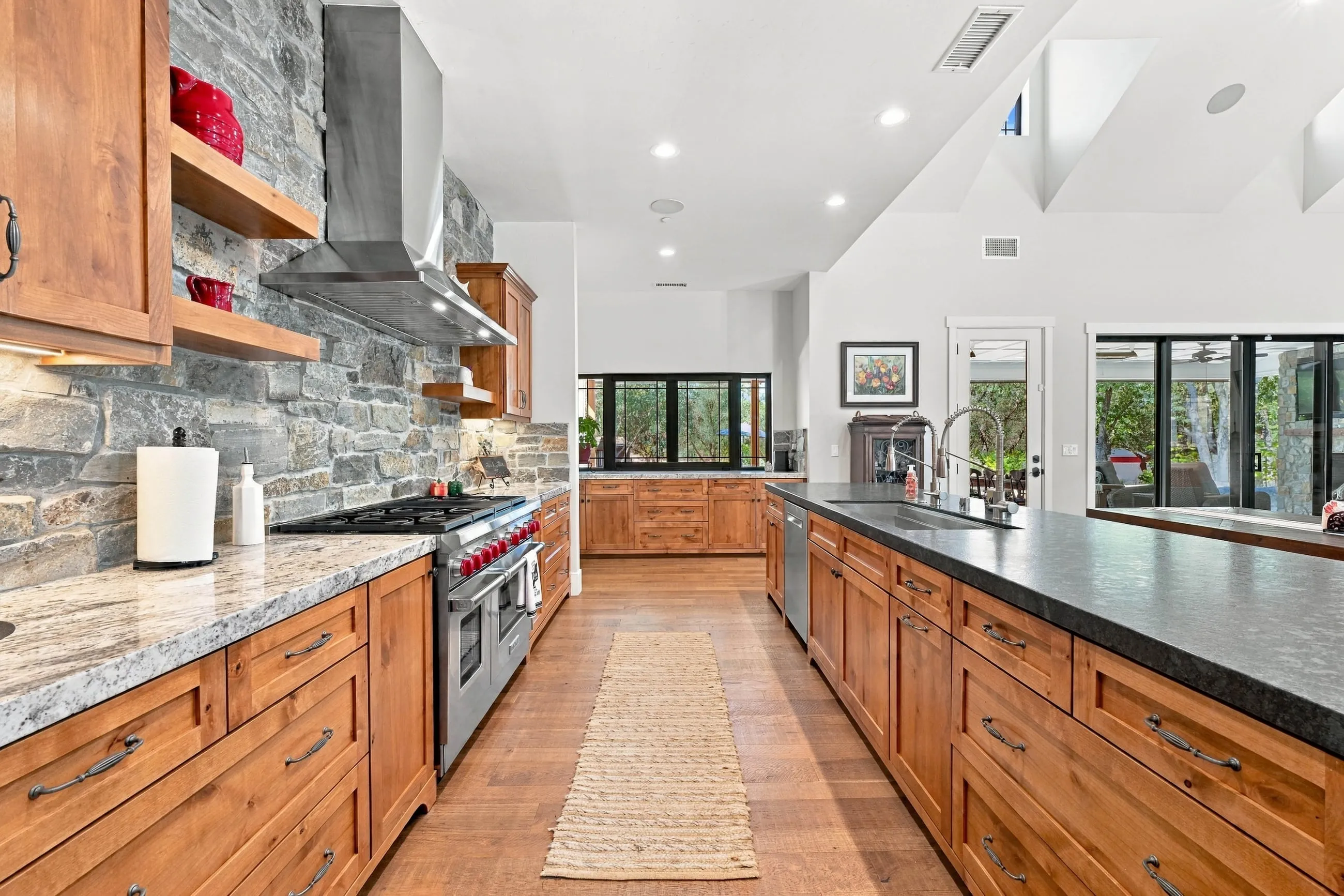 Kitchen galley with leathered granite island and alder cabinetry