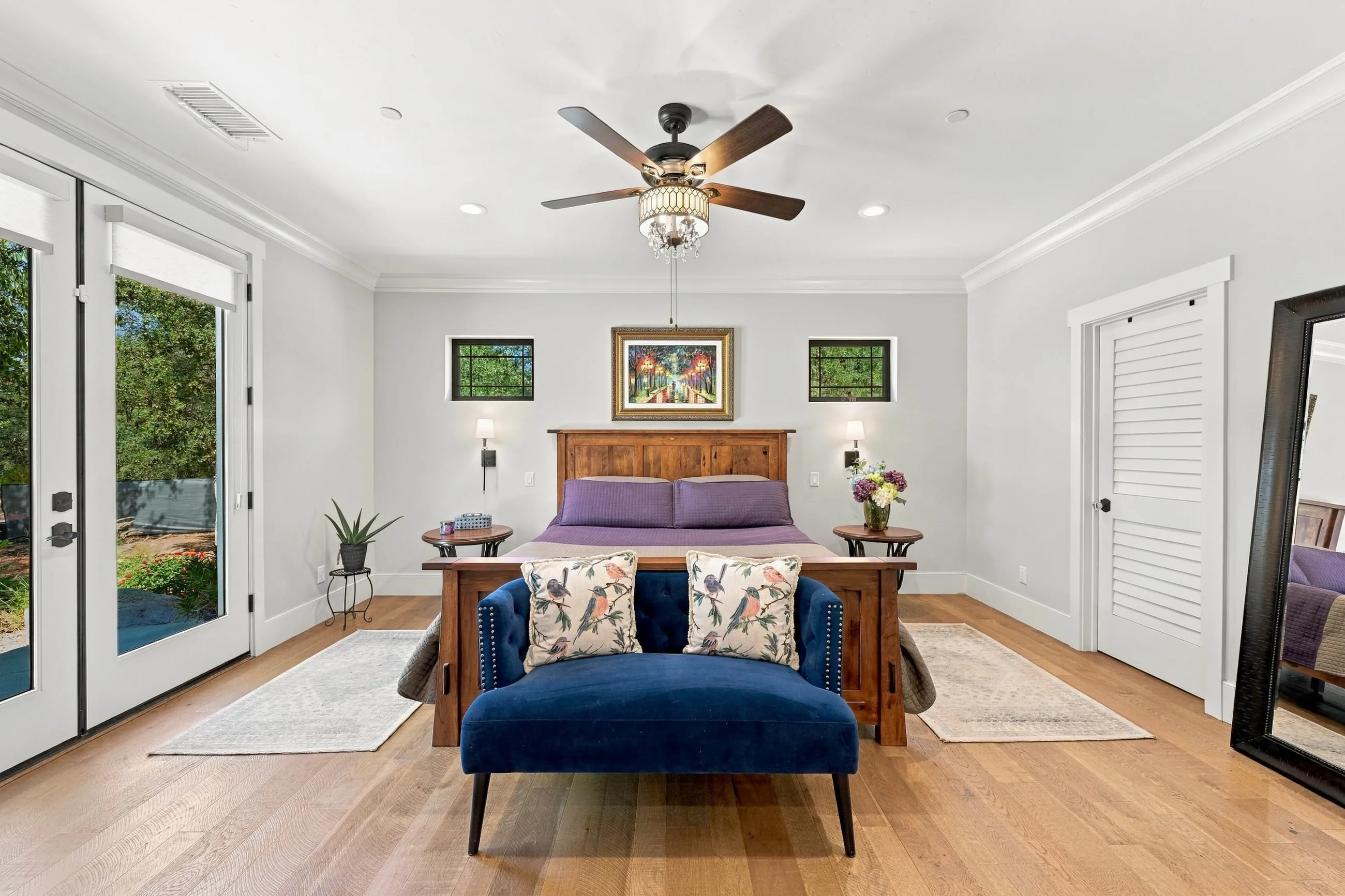 Primary bedroom with French doors opening to the garden