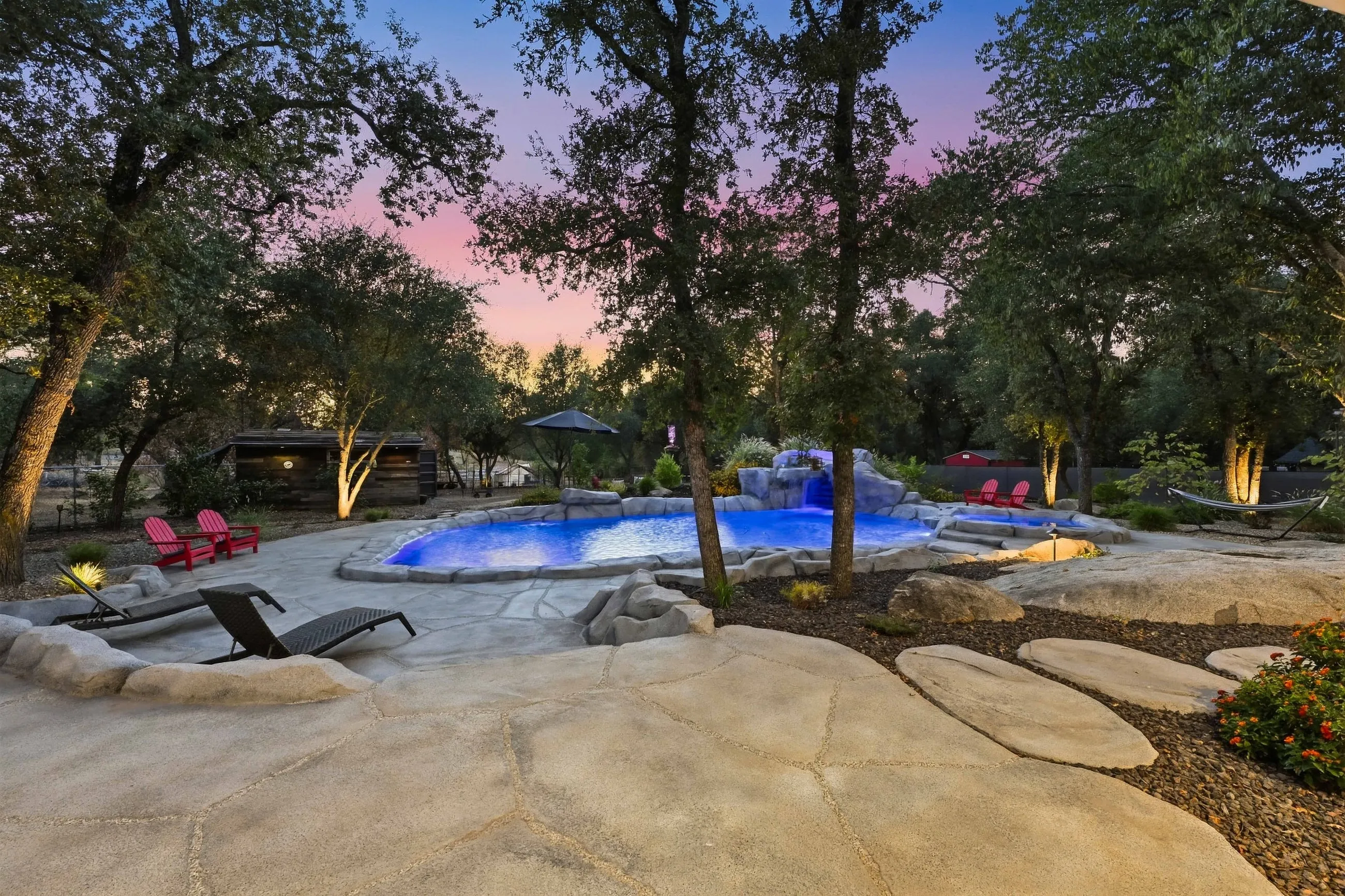 Twilight pool set among granite boulders and oaks