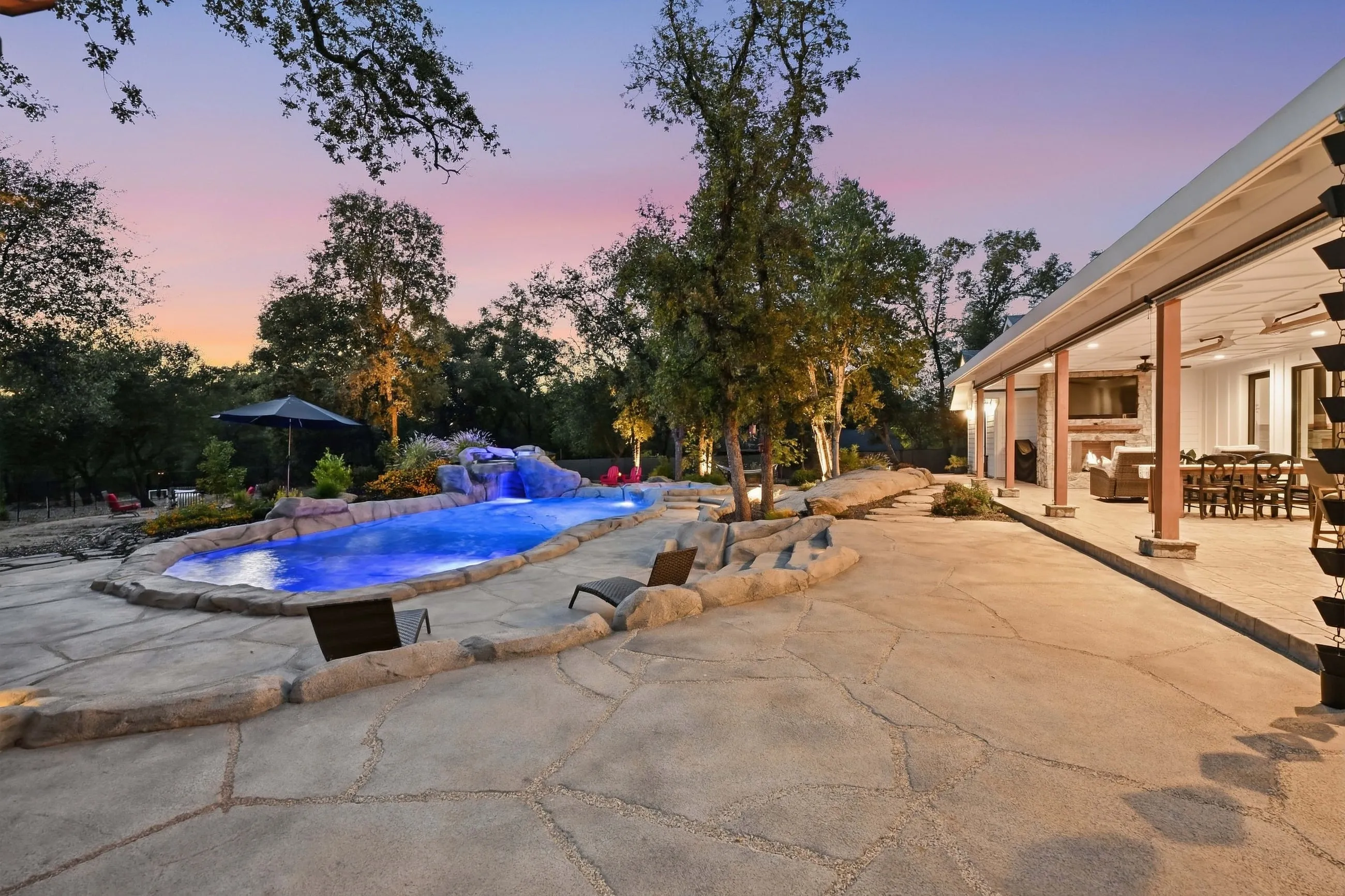 Pool and covered porch at dusk