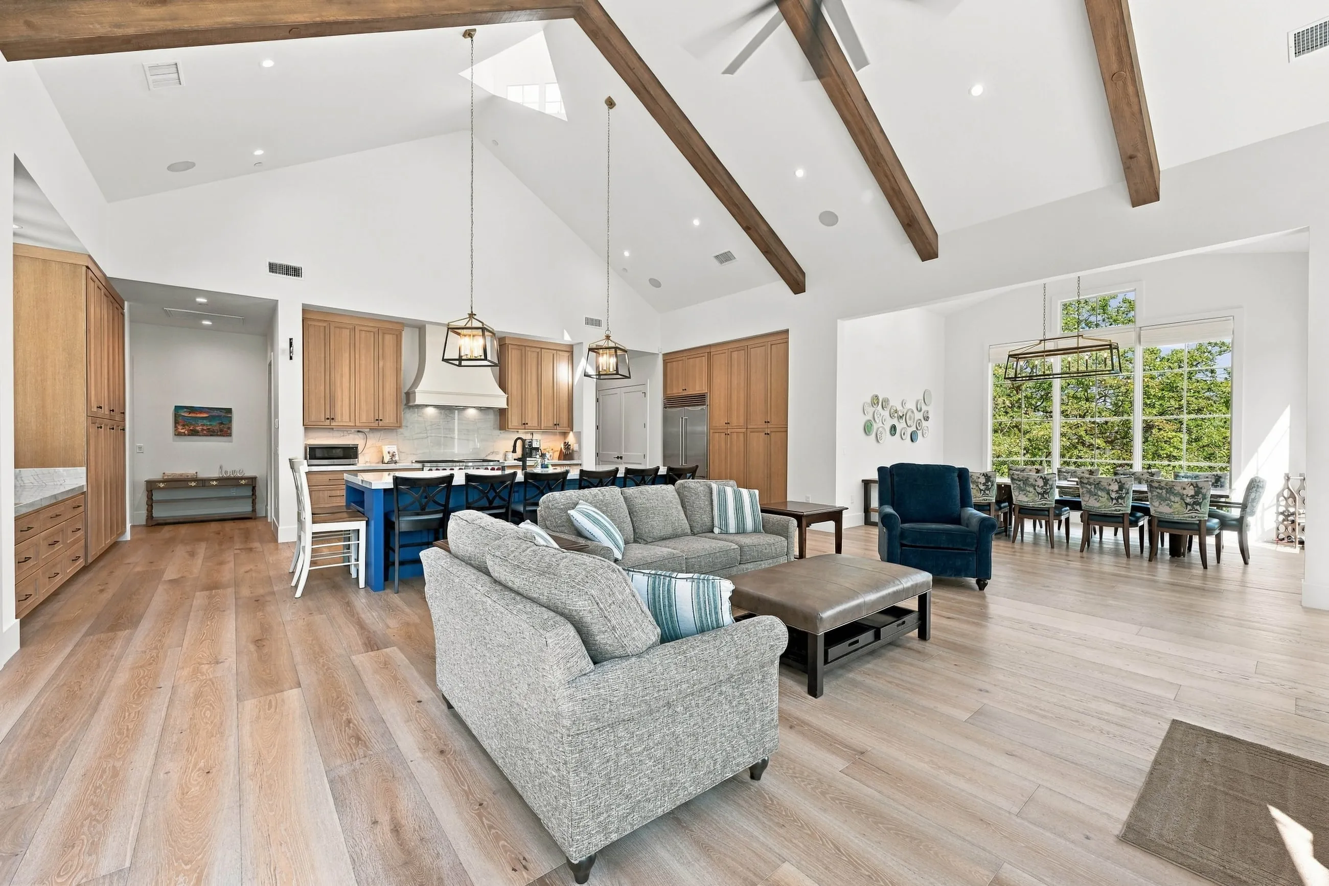 Vaulted great room with stained beams looking toward the open kitchen